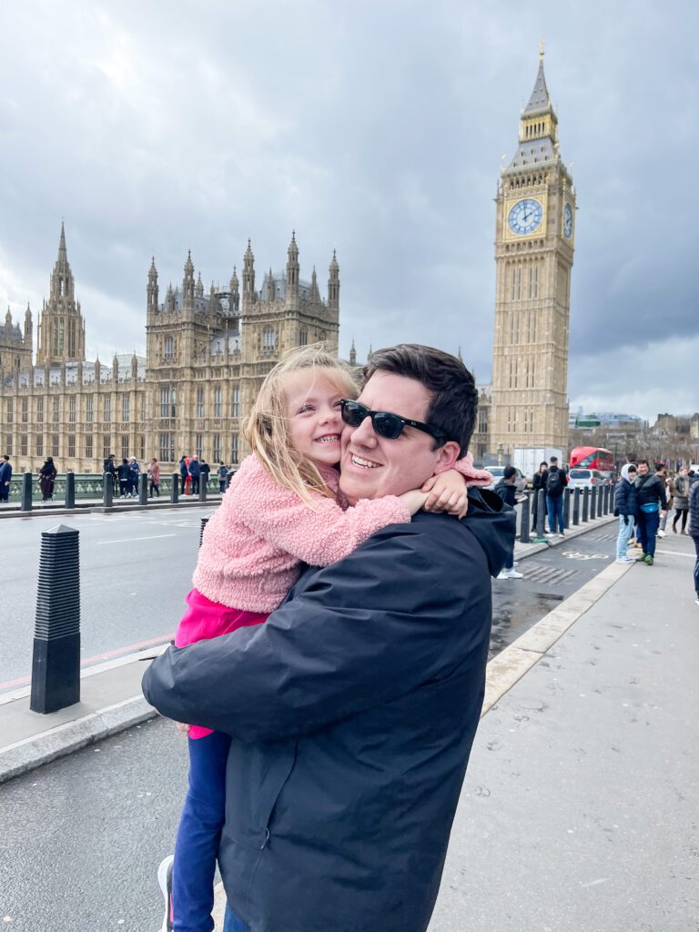 A heartwarming moment in London between father and daughter, showcasing the joys of quitting a job to travel the world with family and create unforgettable memories